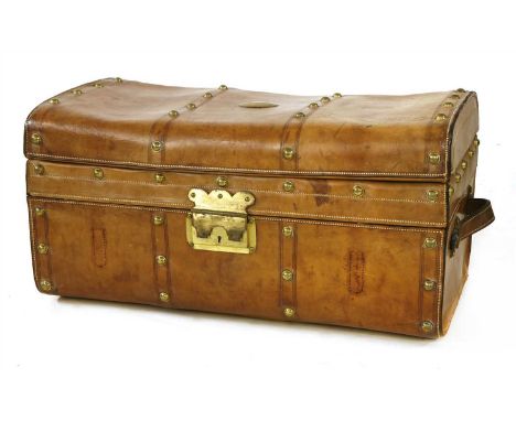 A leather and brass-studded trunk,late 19th century, the lid with a brass plaque inscribed 'C C Jacobsen', lifting to reveal 