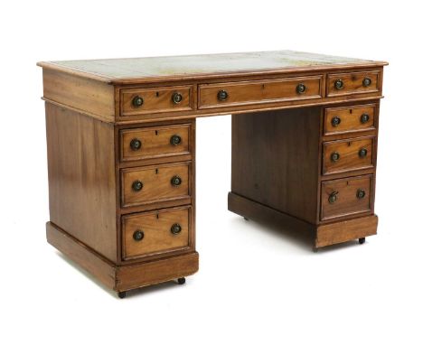 A Victorian mahogany pedestal desk,green gilt tooled leather lined top, fitted nine drawers, later brass ring handles, on pli