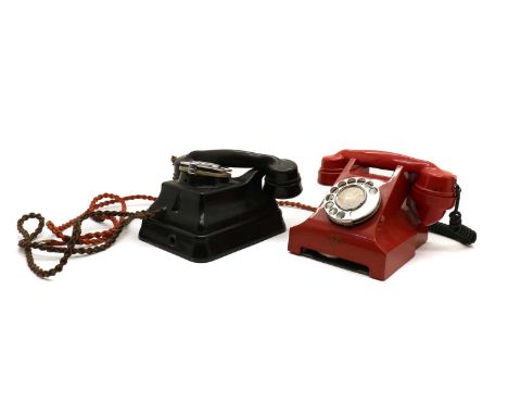 A Siemens red telephone rotary telephone, 1950s, lacking the base tray, label worn,together with a black wall mounted telepho