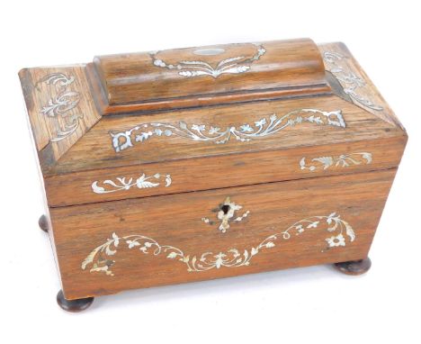 A Regency rosewood and mother of pearl inlaid tea caddy, of sarcophagus form, opening to reveal two lidded compartments, rais