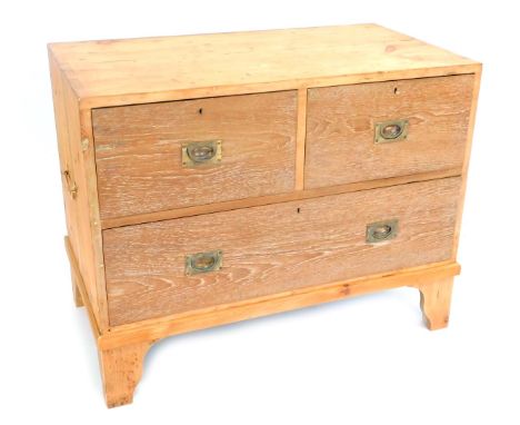 A limed oak and pine military chest, with pair of brass carrying handles, having two deep and one long drawer, raised on brac