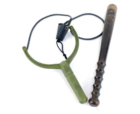 An ebonised policeman's truncheon, 38cm high, and an army sling slot, 26cm high. (2)