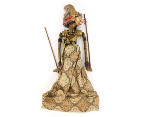 A Balinese carved wooden puppet, of a lady in flowing dress, with gilt material, 50cm high. (AF) 