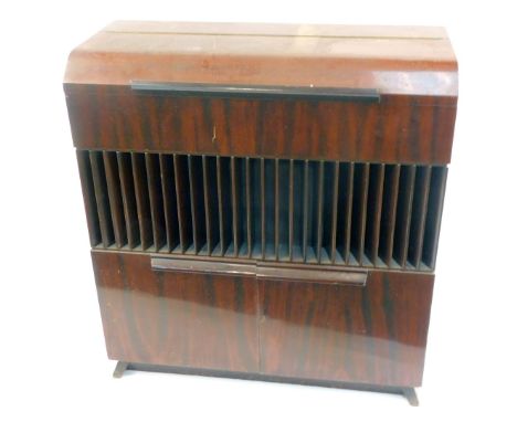 A Decola cased radiogram, with a Garrard record player, model RC88-4, in a walnut finish case, 104cm high, 96cm wide, 40cm de