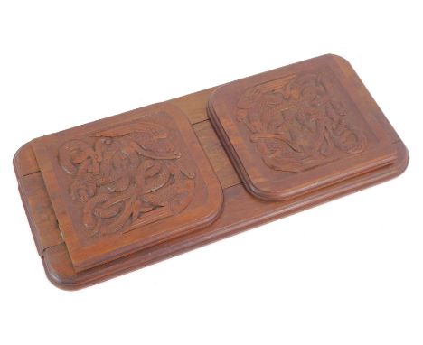 An early 20thC carved Celtic carved oak book slide, with serpent engraved panels, and moulded ends, 37cm wide, 17cm deep. 