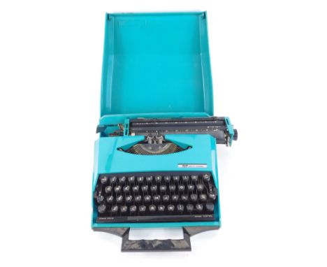 A Smith Corona GT cased portable typewriter, in turquoise case, 27cm wide, 40cm deep.