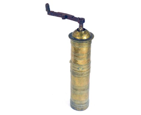 A Turkish brass coffee grinder, with turning handle and ribbed banding, 29cm high. (AF)