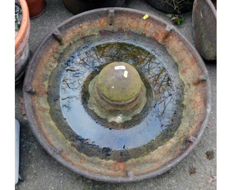 A cast iron metal Mexican hat feeding trough, 70cm diameter. 