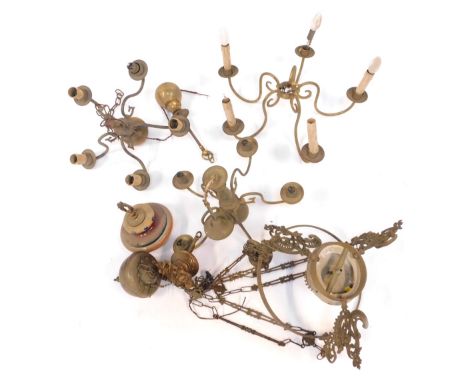 A group of light fittings, comprising three five branch brass chandeliers, a pottery hanging oil lamp, etc. (a quantity)