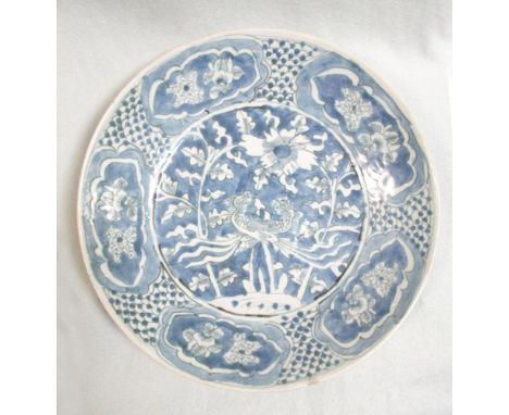 A 17th century Swatow dish, painted with a pair of phoenixes within five flower reserves on a fish scale rim band, 28cm diame