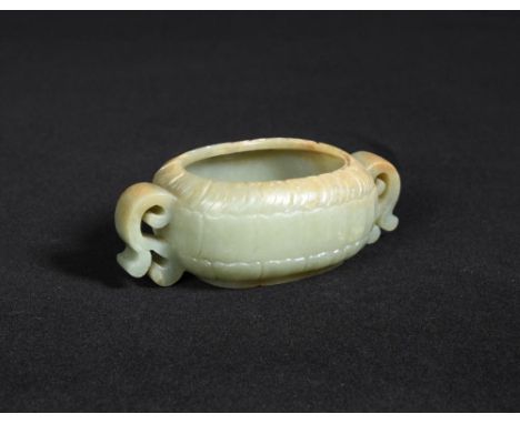 A 19th century jade lotus flower brush washer, the sea green stone with brown tints about the rim and tops on the scroll hand