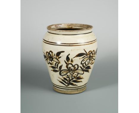 A Ming dynasty Cizhou type jar, the painted ceramic boldly painted with flowers on one side, 24cm high  