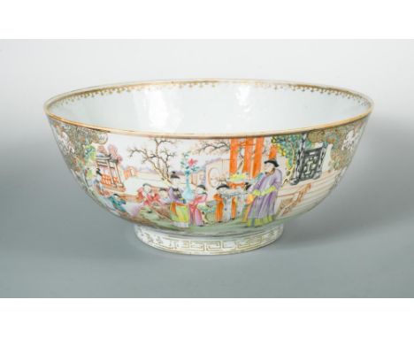 A large Qianlong famille rose punch bowl, the exterior with two large cartouches with gilt scrolled edges, containing diverse
