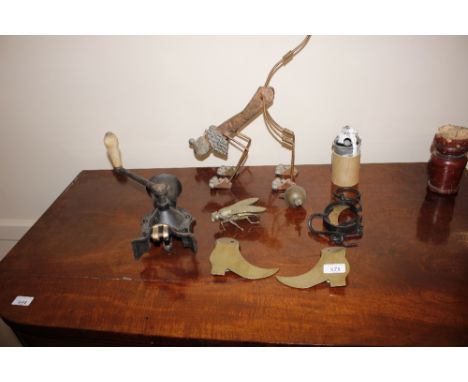 A vintage cast iron mincer; a pair of brass hearth ornaments in the form of boots; a set of old scales; a de-activated grenad