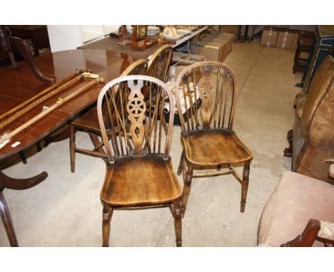 Four stick and wheel back dining chairs