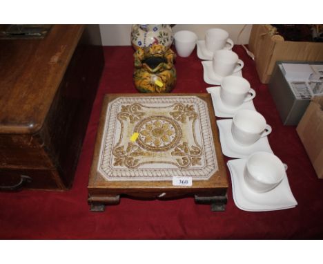 A wooden table stand with tile inset top