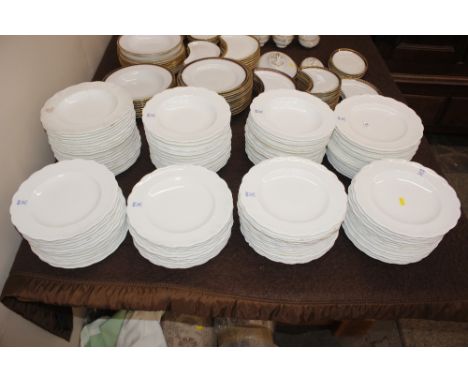 A large quantity of Mintons by T Goode &amp; Co. white glazed dinnerware monogrammed with "H" below coronet etc.