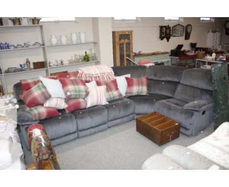 A charcoal corner sofa unit with buttoned upholstery