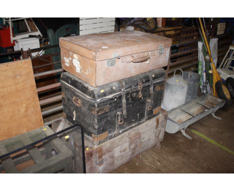 A vintage leather suitcase; a canvas and leather mounted trunk; and a metal bound dome topped trunk