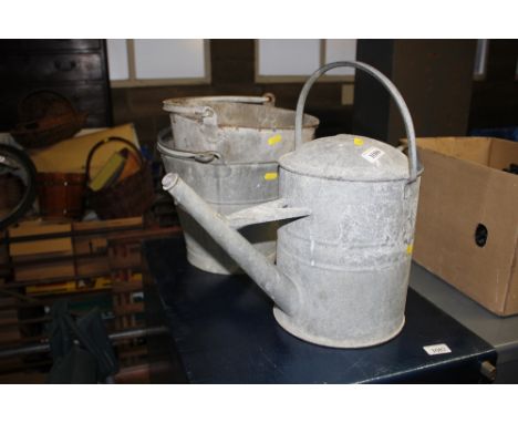 A vintage galvanised watering can; and two galvanised pails