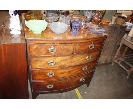 A 19th Century mahogany bow front chest fitted two short and three long drawers, raised on a shaped apron and bracket support