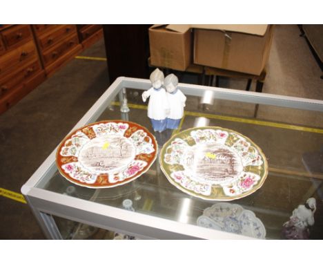 A Nao porcelain figure group depicting two choir boys; and a pair of Mason's ironstone Christmas plates "Buckingham Palace" a