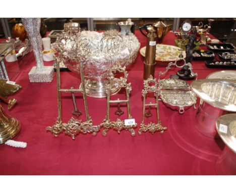 Three graduated brass easel photograph stands in the Rococo manner