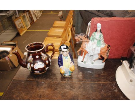 A 19th Century bargeware teapot (lid missing); a Toby jug and a Staffordshire flat back figure 