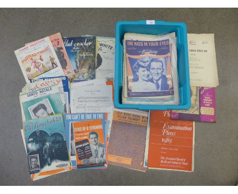 A collection of books, including two first edition Harry Potter books, a collection of sheet music and a vintage travel chess