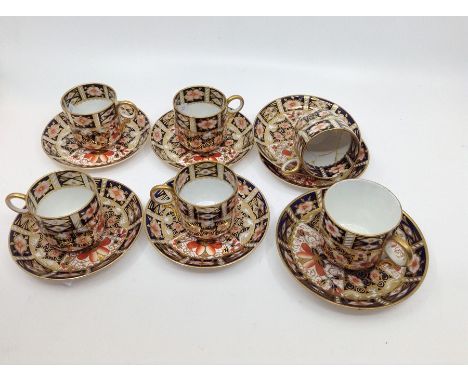 A set of five Royal Crown Derby Imari 2451 pattern coffee cups and 6 saucers (1 cup broken and repaired but requires restorat