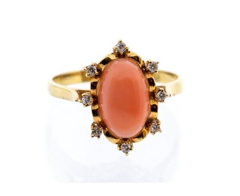 A coral and diamond 18ct yellow gold ring, comprising an oval coral set to the centre within a border of small brilliant cut 