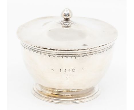 An Arts &amp; Crafts style silver bowl and cover, beaded rim above plain body on raised foot, the body engraved 1946 with int