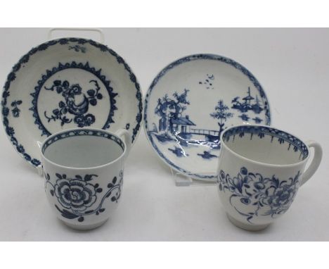 Two 18th century Worcester blue and white tea cups, painted with floral sprays; and two blue and white saucers, one in the Ch