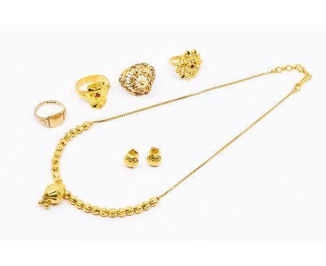 A 22ct gold necklace, comprising a faceted sphere with beaded tassel suspended from a row of diamond cut beads to a box link 