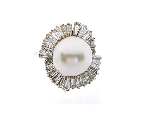 A pearl and diamond 18ct white gold ring, the cultured pearl set to the centre approx 13mm, white with pink overtone, within 
