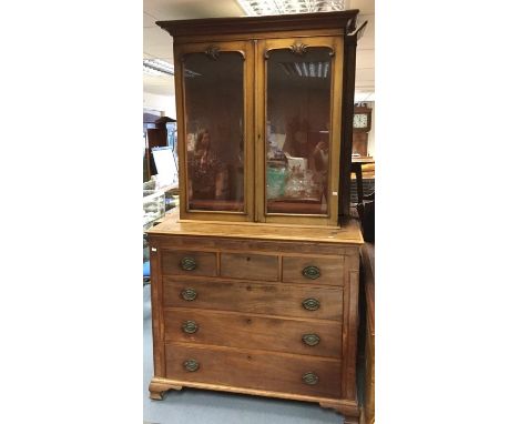 A George III later mahogany bookcase on chest, the upper bookcase section of circa 1870, having a projected moulded cornice o