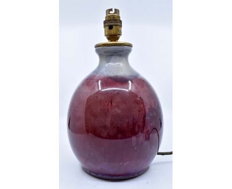 Ruskin Pottery: A Ruskin Pottery high fired lamp base with sang de boeuf glaze, silver grey neck and brass fittings, height a