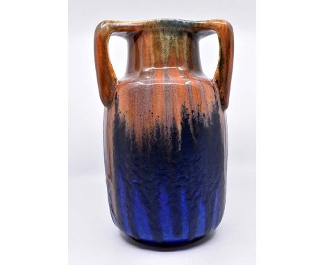 Ruskin Pottery: A Ruskin Pottery three handled baluster vase with orange/brown base glaze with blue drip glaze overlay, heigh