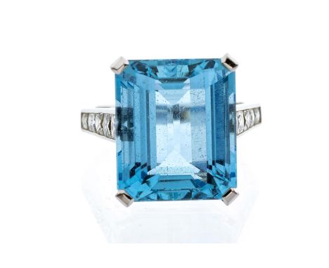 An aquamarine and diamond platinum cocktail ring, the claw set step cut aquamarine weighing approx 18.5carats, each shoulder 