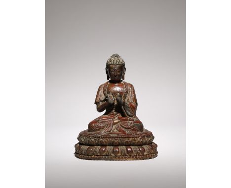 A CHINESE LACQUERED AND GILT-WOOD FIGURE OF BUDDHA DIPANKARA LATE MING DYNASTY Carved seated in dhyanasana upon a double lotu