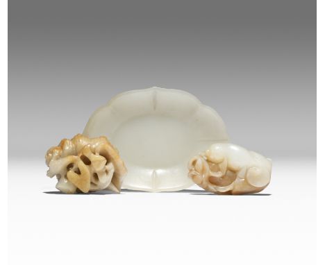 THREE SMALL CHINESE CELADON JADE ITEMS QING DYNASTY One carved in pale celadon jade as a shallow dish with a foliate rim, ano