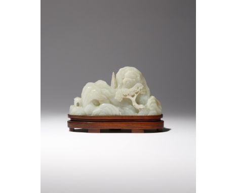 A CHINESE CELADON JADE 'MOUNTAIN' CARVING QIANLONG 1736-95 Formed as rounded craggy peaks, decorated in relief to one side wi