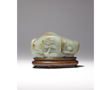 A CHINESE CELADON JADE 'BOULDER' CARVING QING DYNASTY Naturalistically formed as a craggy rock, carved to one side with a pin