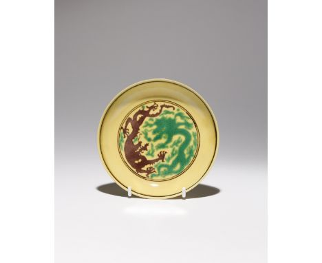 A CHINESE IMPERIAL YELLOW-GROUND 'DRAGON' SAUCER DISH SIX CHARACTER KANGXI MARK AND OF THE PERIOD 1662-1722 Incised with two 