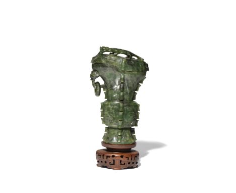 A CHINESE ARCHAISTIC SPINACH-GREEN JADE VASE AND COVER LATE QING DYNASTY Shaped as a pouring vessel flaring at the rim, the c