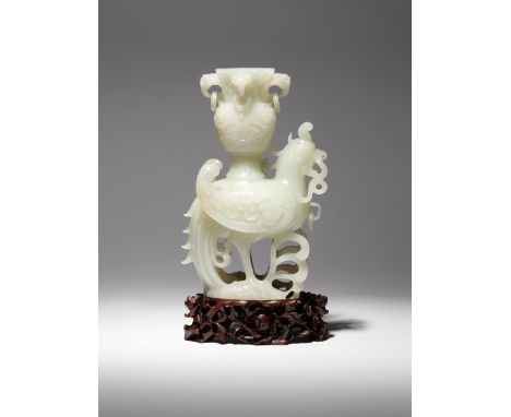 A CHINESE WHITE JADE 'TIANJI' VASE LATE QING DYNASTY/REPUBLIC PERIOD The heavenly bird carved standing upon rocks, its wings 