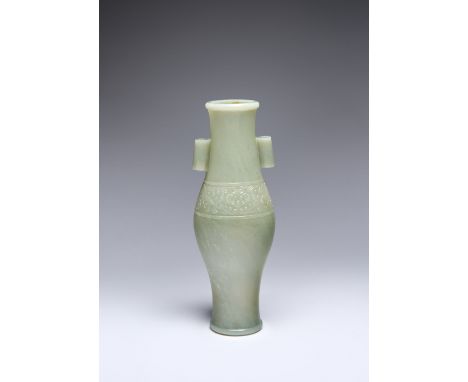 A FINE TALL CHINESE CELADON JADE OVOID VASE 18TH CENTURY The slender body swelling at the centre, carved in low relief to the