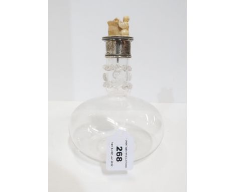 A glass decanter with silver mounts with marks for Holland Aldwinckle and Slater London 1906 with an ivory netsuke finial Con
