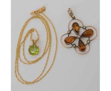 A 14k gold peridot pendant and chain weight together 2.3gms, and a 9ct Edwardian citrine and pearl flower pendant, weight 2.4