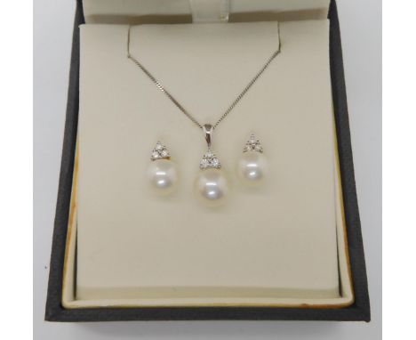 A 9ct white gold pearl and diamond pendant and chain, together with a pair of matching earrings, weight together 3.1gms Condi